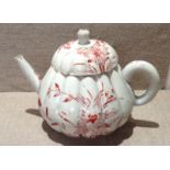 AN 18TH CENTURY CHINESE PORCELAIN TEAPOT Hand painted with an iron red flower motif, with a fluted