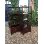 A PAIR OF 20TH CENTURY MAHOGANY FLOOR STANDING SHELVES Of four tiers, with cupboards below, of