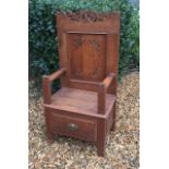 AN EARLY 20TH CENTURY OAK HALL CHAIR Fashioned in the 16th Century style, with pierced and carved