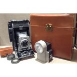 POLLAROID 110A, A VINTAGE CAMERA Having a grey plastic case, together with a light meter and spare