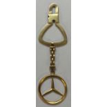 AN 18CT GOLD MERCEDES KEYRING For attachment to car keys, stamped '750'. (9.7cm x 2.7cm) 5092/