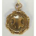 AN EARLY 20TH CENTURY HALLMARKED 9CT ROSE GOLD PRESENTATION MEDAL The circular medal having a shield