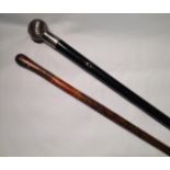 AN ANTIQUE EBONISED WOOD MARCHING BATON  With a silver plated spherical handle, having ribbed