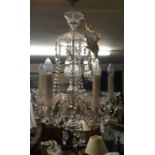 A DECORATIVE GLASS FIVE BRANCH CHANDELIER Hung with prism drops. (drop 64cm)