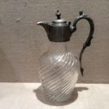 AN EDWARDIAN SILVER PLATED AND GLASS CLARET JUG Having a circular finial and fluted spout, mounted