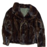 A VINTAGE LADIES FUR COAT Of small size, with a high collar and the interior hand sewn. (approx
