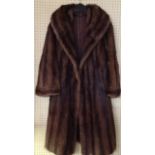 AN ANTIQUE MINK FUR COAT Having a wide collar and brown fabric lining.  (approx l 104cm)