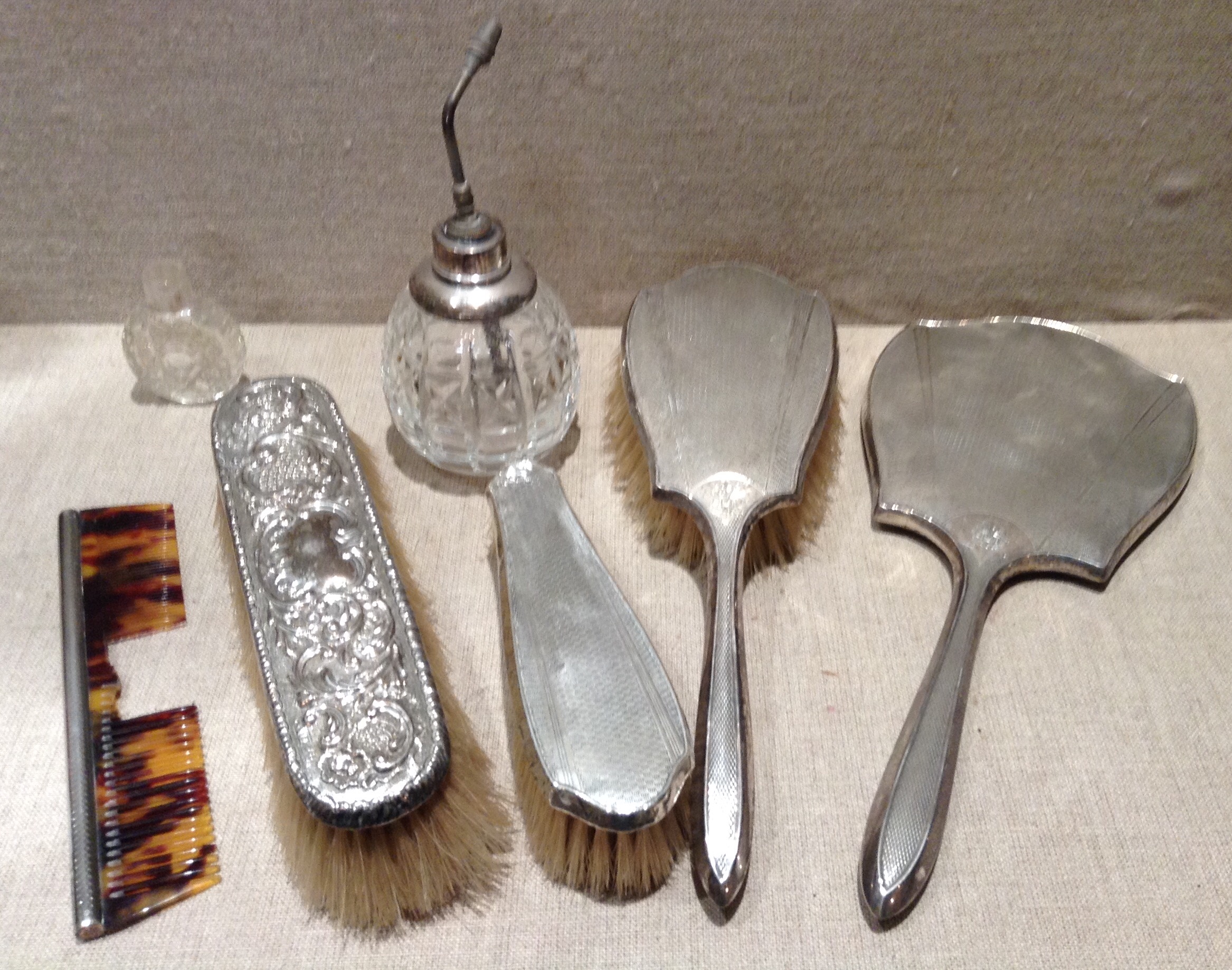 AN EARLY 20TH CENTURY HALLMARKED SILVER DRESSING TABLE SET Comprising a hand mirror, with Art Deco