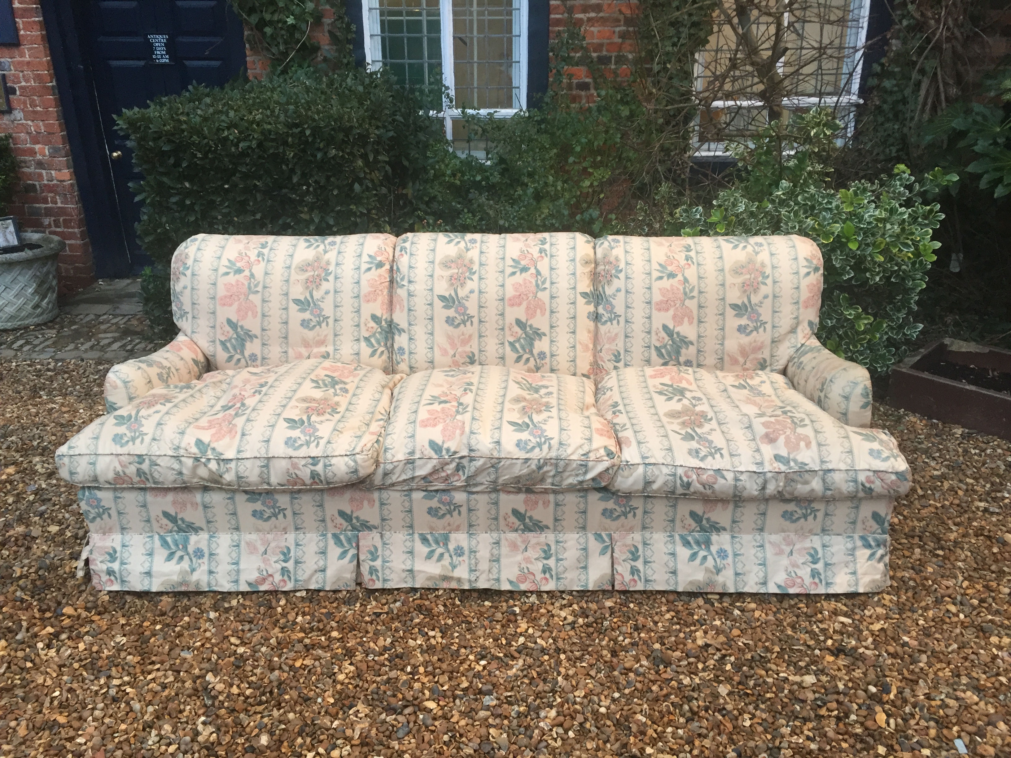 HOWARD CHAIRS LTD, A LARGE THREE SEATER SETTEE In later floral fabric upholstery, raised on six - Image 2 of 2