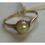 A HALLMARKED 9CT GOLD AND CULTURED PEARL DRESS RING The 5.5mm oval white pearl, in a pierced