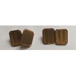 A PAIR OF MID 20TH CENTURY HALLMARKED 9CT GOLD CUFFLINKS The rectangular plaques with striped engine