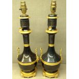 A PAIR OF NEOCLASSICAL STYLE BRONZE ORMOLU LAMPS The bronze body having a gilded ormolu waistband,