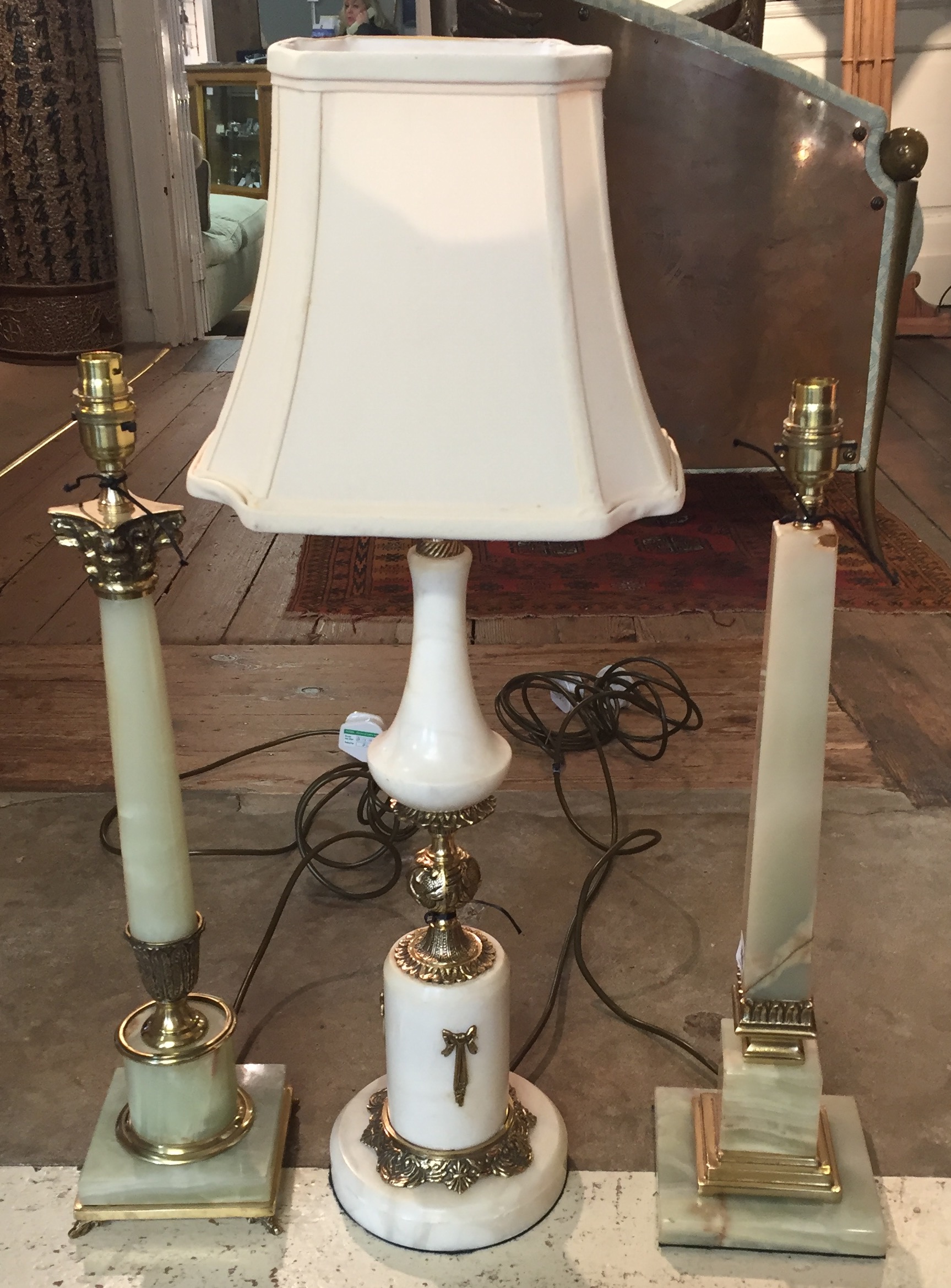 THREE ONYX AND BRASS TABLE LAMPS.
