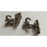 A PAIR OF HALLMARKED SILVER CUFFLINKS Each cufflink comprises a pound sign and a dollar sign,