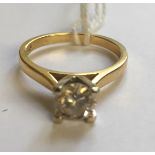 A HALLMARKED 18CT GOLD AND DIAMOND SOLITAIRE RING The brilliant cut diamond in a high four claw