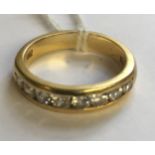 A HEAVY 18CT GOLD AND DIAMOND HALF HOOP/ETERNITY RING The eight brilliant cut diamonds channel set