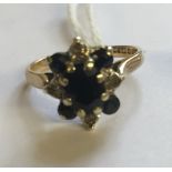 A HALLMARKED 9CT GOLD, SAPPHIRE AND DIAMOND CLUSTER/DRESS RING The oval cut sapphire claw set, to an