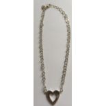 JASPER CONRAN, A SILVER HEART PENDANT AND CHAIN The solid silver open heart pendant, inset to one