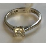 A HALLMARKED 18CT WHITE GOLD AND DIAMOND SOLITAIRE RING The brilliant cut diamond in a four claw