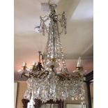 A LATE 19TH CENTURY FRENCH GILT METAL NINE BRANCH CHANDELIER Hung with numerous prisms. (w 56cm x