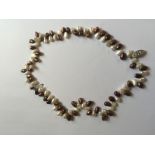 A DOUBLE STRAND BROWN AND WHITE FRESHWATER PEARL BRACELET The two strands of alternate brown and