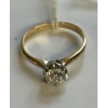 A HALLMARKED 18CT GOLD AND DIAMOND SOLITAIRE RING The brilliant cut diamond illusion set, to plain