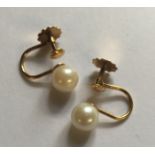 A PAIR OF 9CT GOLD AND CULTURED PEARL EARRINGS Each earring features a 6.3mm white cultured pearl,