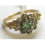 AN 18CT BICOLOUR GOLD, TOPAZ AND DIAMOND FLOWERHEAD DRESS RING The round cut pale blue topaz claw