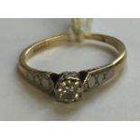 A VINTAGE 18CT GOLD, PLATINUM AND DIAMOND SOLITAIRE RING The brilliant cut diamond claw set, in