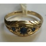 A HALLMARKED 9CT GOLD AND SAPPHIRE THREE STONE RING The three graduated round cut sapphires gypsy