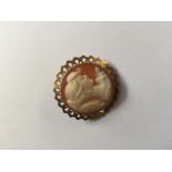 A VINTAGE HALLMARKED 9CT GOLD CAMEO BROOCH The circular carved shell cameo, depicting the bust of