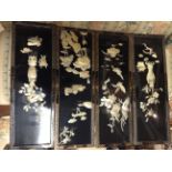 A SET OF FOUR ORIENTAL BLACK LACQUER AND MOTHER OF PEARL WALL PANELS Each finely carved with typical