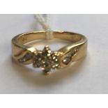 AN 18CT GOLD AND DIAMOND FLOWERHEAD CLUSTER/DRESS RING The six single cut diamonds claw set, in a