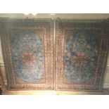 A RARE AND FINE PAIR OF ISFAHAN SILK AND WOOLLEN RUGS The pale blue fields having complex central