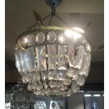 AN EARLY 20TH CENTURY BASKET CHANDELIER Hung with faceted prism drops, on a gilded band.