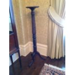 A 19TH CENTURY TORCHÈRE With a twist column.