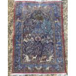 A PART SILK AND PART WOOL ISFAHAN RUG The central madder field woven with beasts and medallion,