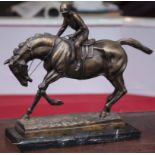 A BRONZE RACEHORSE AND JOCKEY Raised on a marble plinth. (15" x 14")