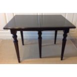 A FRENCH STYLE EBONISED EXTENDING DINING TABLE Complete with two extra leaves, the legs of tapered