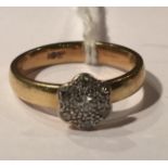 AN ART DECO PERIOD AND LATER 10CT GOLD AND PLATINUM SET DIAMOND FLOWERHEAD PLAQUE RING The brilliant