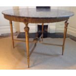 A CIRCULAR ORMOLU FRAMED MARBLE TOPPED TABLE The four legs joined by cross stretchers to join at urn