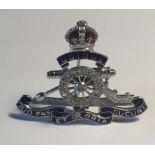 AN 18CT WHITE GOLD ROYAL ARTILLERY BADGE With a crown above a diamond encrusted cannon.