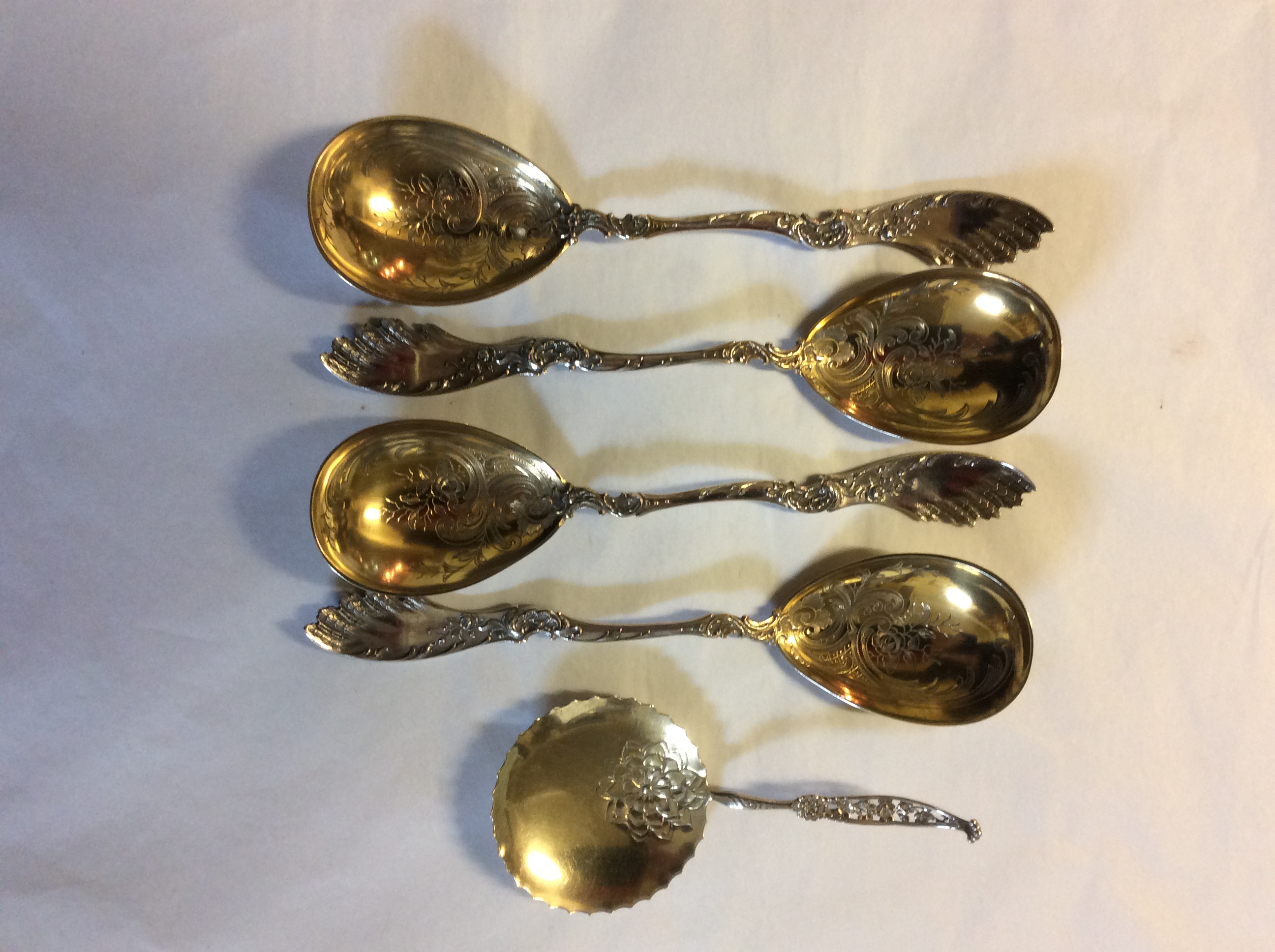 VON MÜNCHHAUSEN, AN EARLY 20TH CENTURY GERMAN SILVER GILT SET OF SERVING SPOONS Each finely engraved