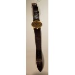 GUCCI, 3400F, A MID SIZE GOLD TONE WRISTWATCH On a lizard skin lock leather strap. NS34 Condition: