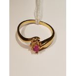 AN 18CT GOLD, RUBY AND DIAMOND CLUSTER/DRESS RING The oval cut ruby to a half surround of diamond