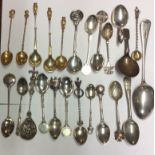 A COLLECTION OF EARLY 20TH CENTURY SILVER GILT, SILVER AND SILVER PLATED COLLECTORS SPOONS To