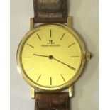 JAEGER LE COULTRE, AN 18CT GOLD GENT'S WRIST WATCH No. 9212 12 Having a circular gold tone dial with