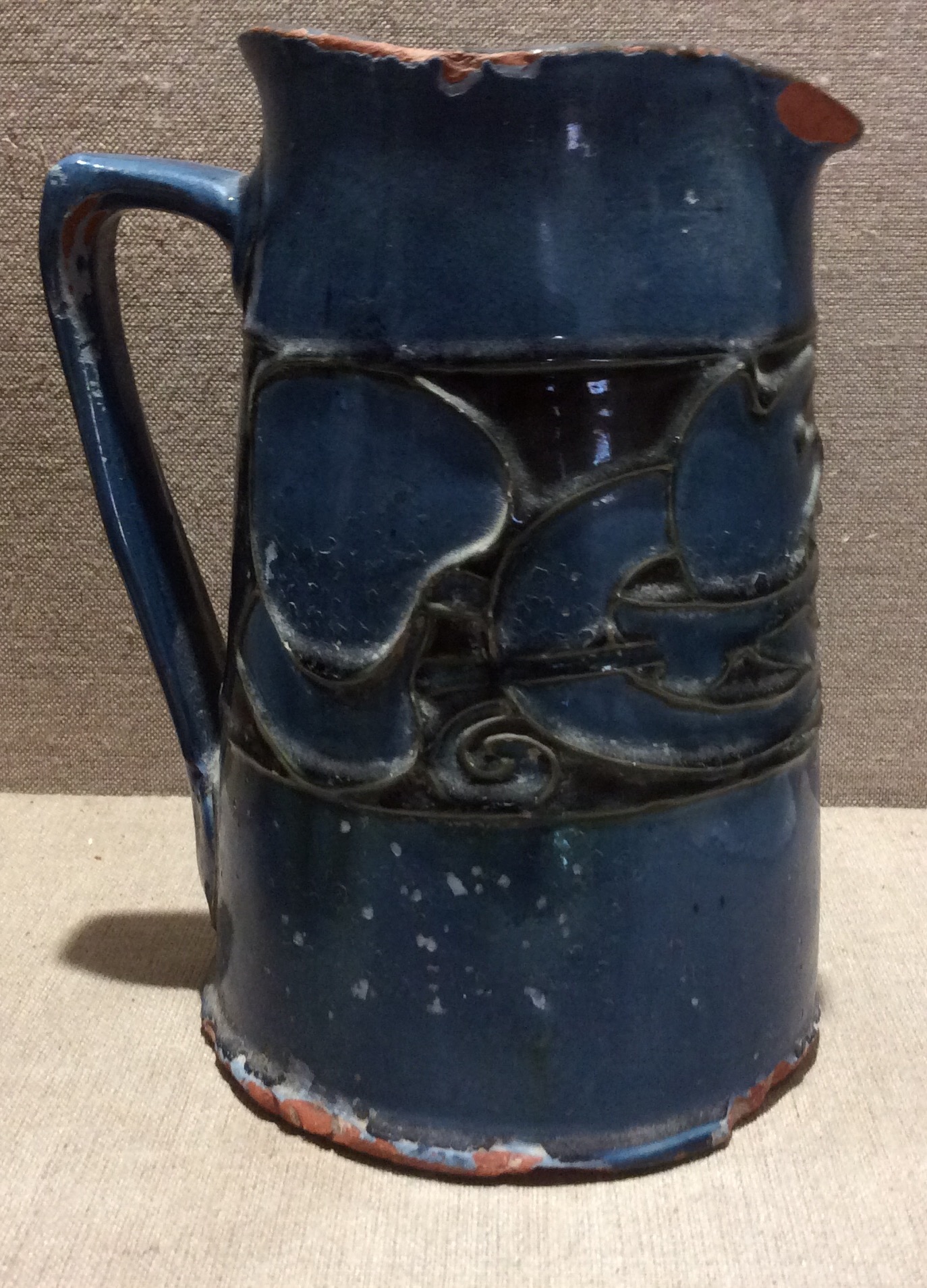 LIBERTY & CO., BARUM, NORTH DEVON, A LATE 19TH CENTURY POTTERY JUG The blue glaze with a