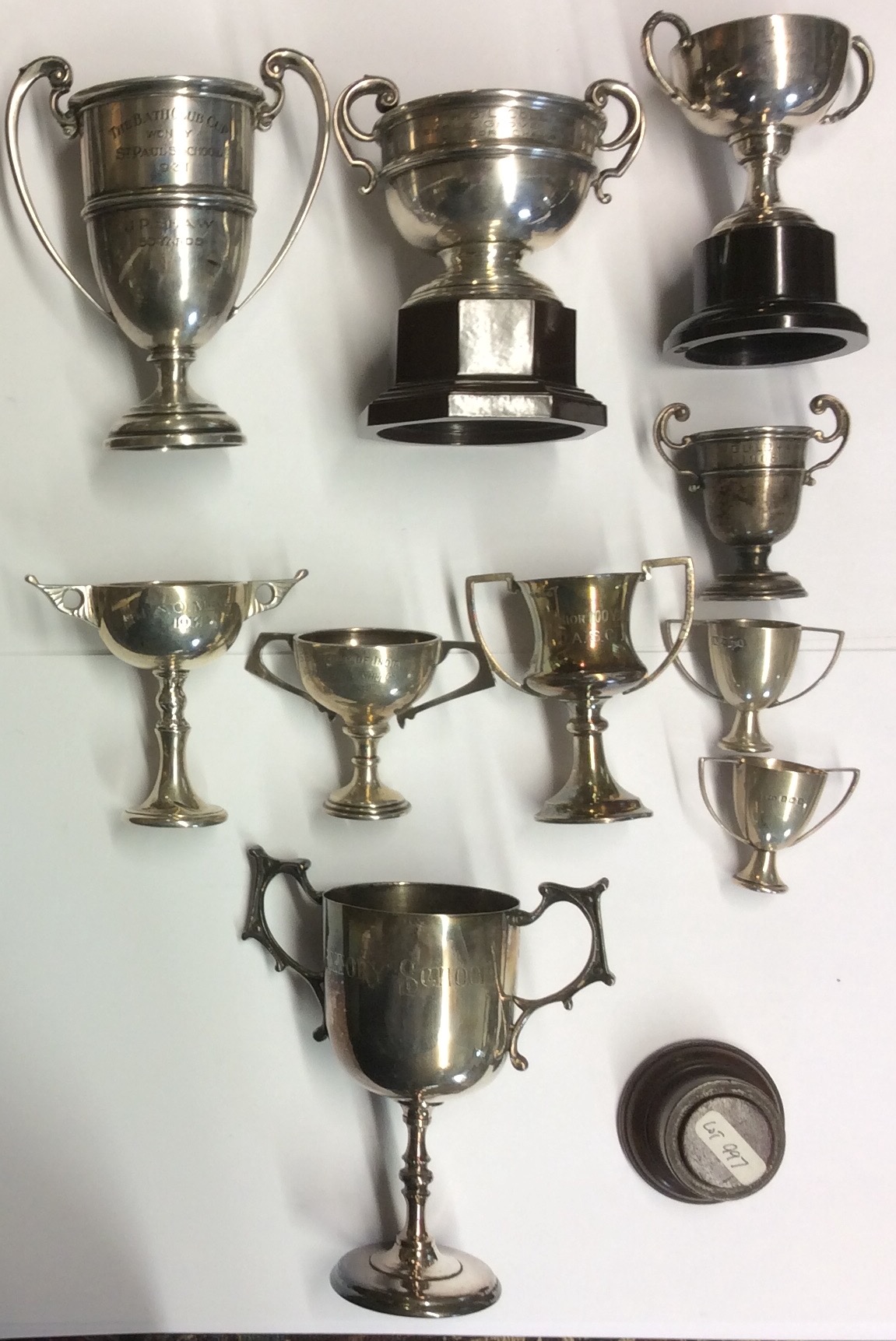 A COLLECTION OF NINE VINTAGE HALLMARKED SILVER MINIATURE PRESENTATION TROPHIES To include The Bath