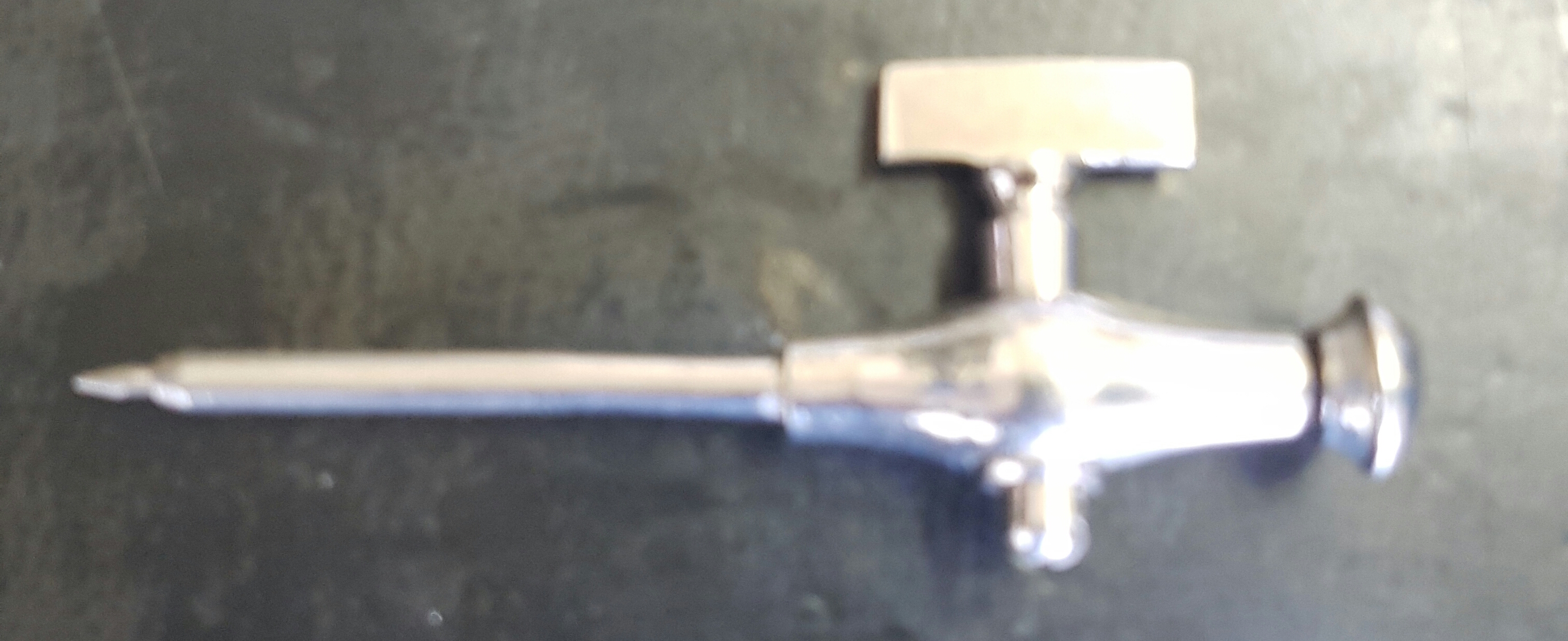 AN EARLY 20TH CENTURY SILVER PLATED CHAMPAGNE TAP Having a rectangular key wind mechanism.